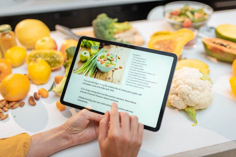 Person follows a digital recipe on a tablet.