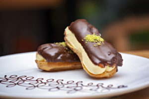 Chocolate pastry eclair dessert on white plate