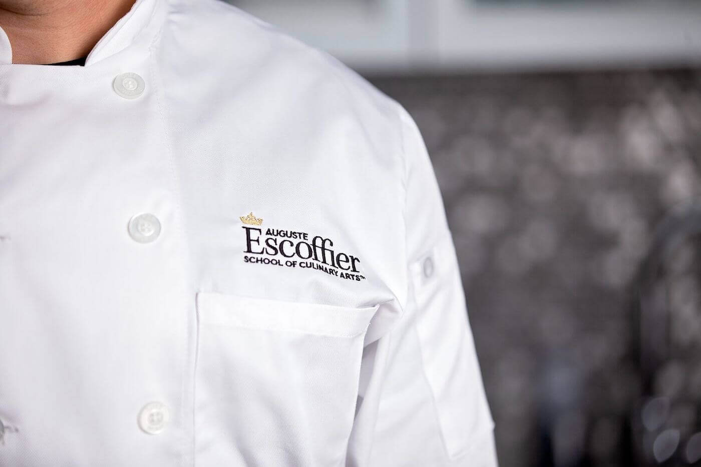 https://www.escoffier.edu/wp-content/uploads/2022/08/Escoffier-logo-on-a-chefs-coat-1400.jpeg
