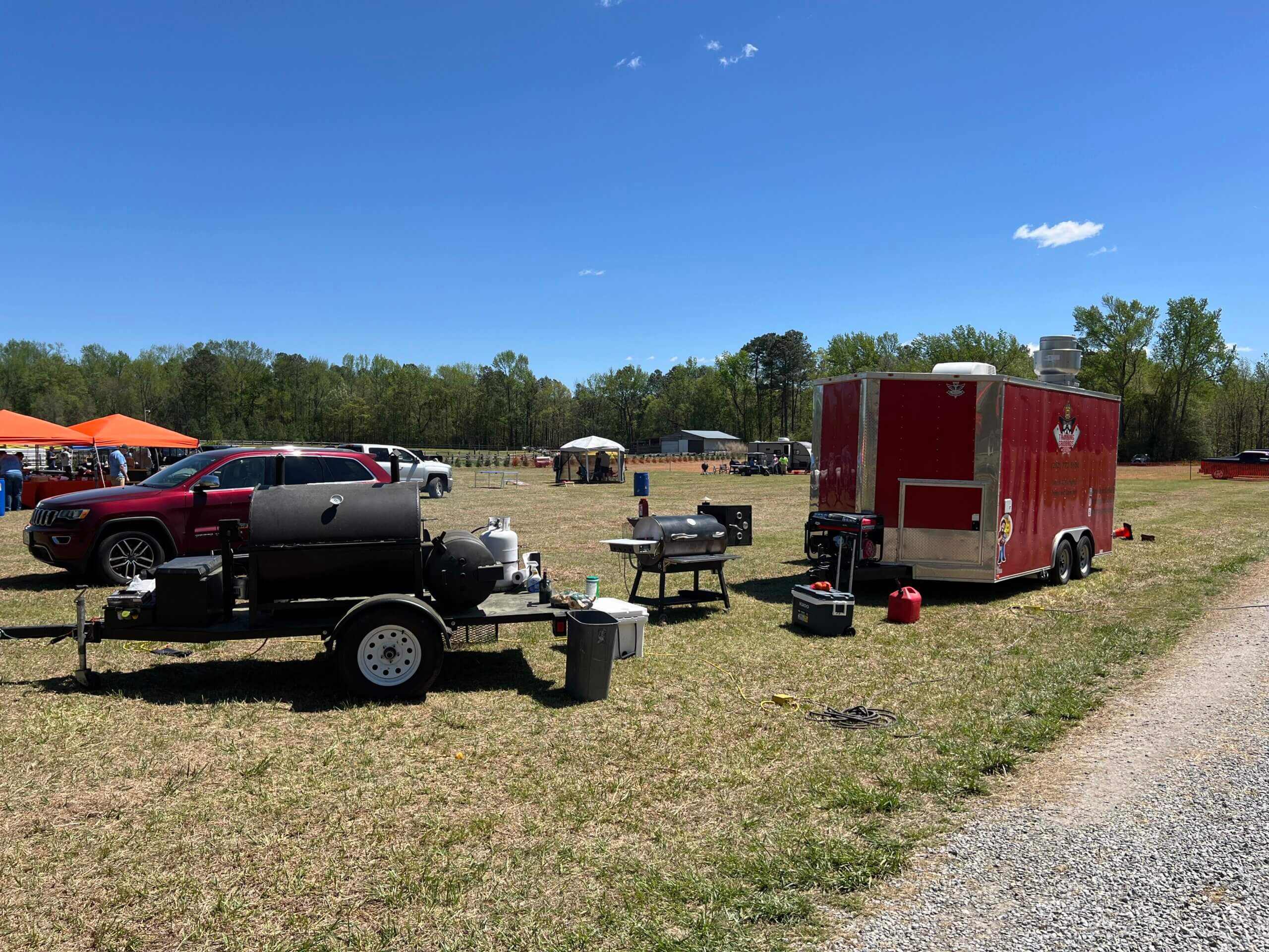 A mobile BBQ foos truck sits in a large open field